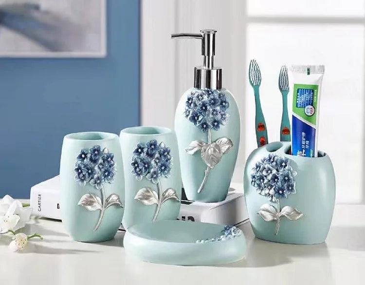 KTX-497491 Flower Pattern Polyresin Bathroom Accessory Set in Blue - Includes Lotion Dispenser, Toothbrush Holder, Soap Dish, Tumbler, Toilet Brush Holder, Amenity Tray, Tissue Cover, and Waste Bin